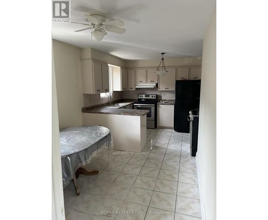 A kitchen with a table and chairs in it.