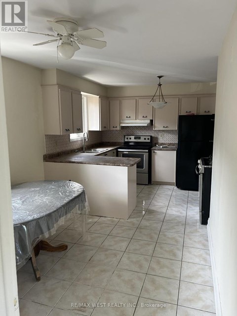 A kitchen with a table and chairs in it.