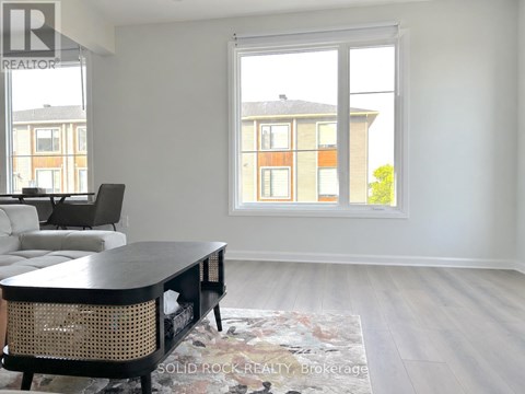 A living room with a black table and chairs.