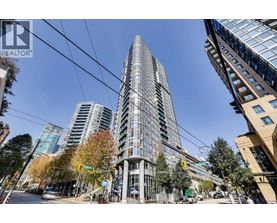 A tall building with many windows is in the center of the image.