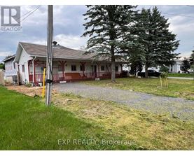 A house with a gravel driveway in front of it.