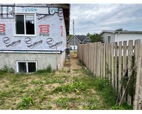 A house under construction with a NovaWrap insulation advertisement on the wall.