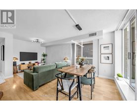 A living room with a green couch and a wooden table.