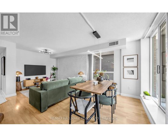 A living room with a green couch and a wooden table.