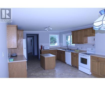 A kitchen with wooden cabinets and white appliances.