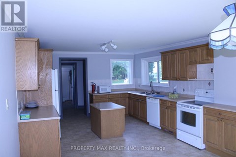 A kitchen with wooden cabinets and white appliances.