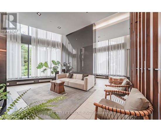 A living room with a white couch and a wooden coffee table.
