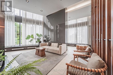 A living room with a white couch and a wooden coffee table.