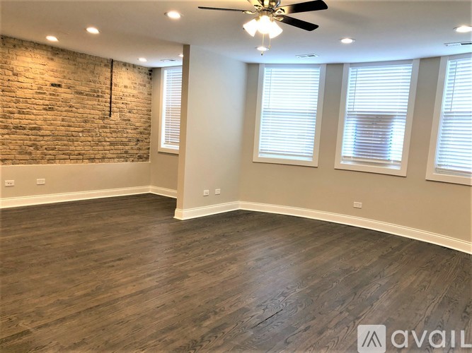 A room with a brick wall and wooden flooring.