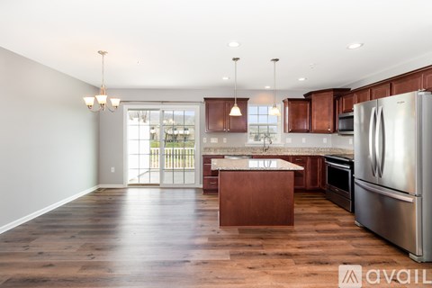 A kitchen with wooden cabinets and stainless steel appliances.