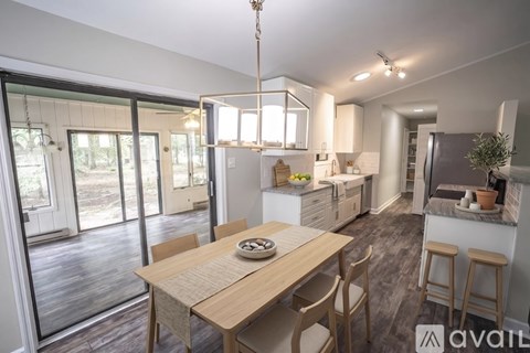 A modern kitchen with a dining table and chairs.