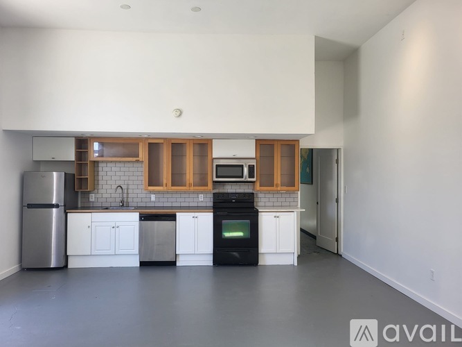 A kitchen with white cabinets and a black oven.