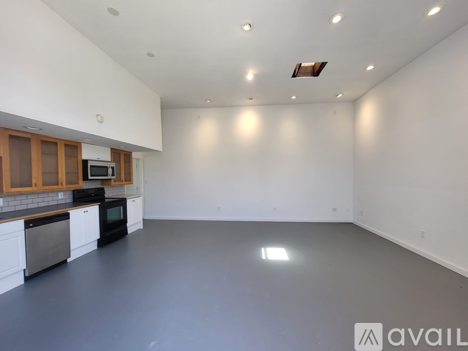 A spacious kitchen with white cabinets and a microwave above the stove.