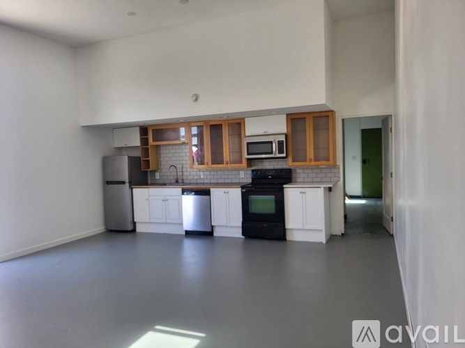 A kitchen with white cabinets and a black stove top oven.