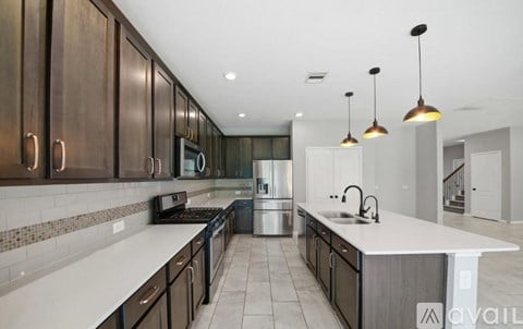A modern kitchen with dark wood cabinets and white countertops.