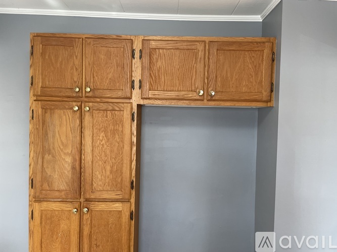 A wooden double door cabinet with two doors on top and two doors on the bottom.