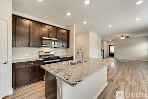 A kitchen with brown cabinets and a granite countertop.