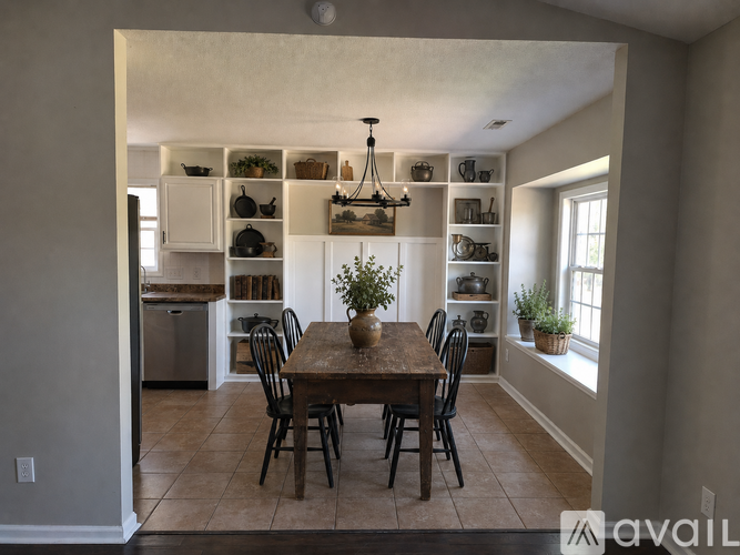 A dining room with a table set for four.