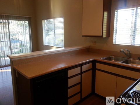 A kitchen with a sink and a window.