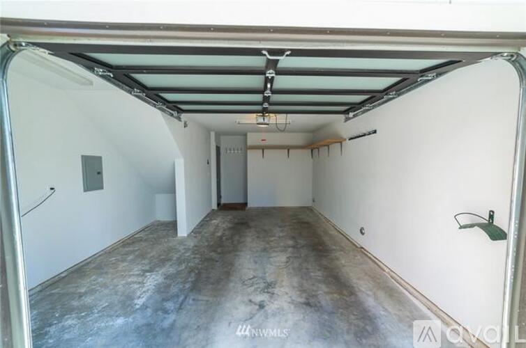 A spacious garage with a concrete floor and white walls.