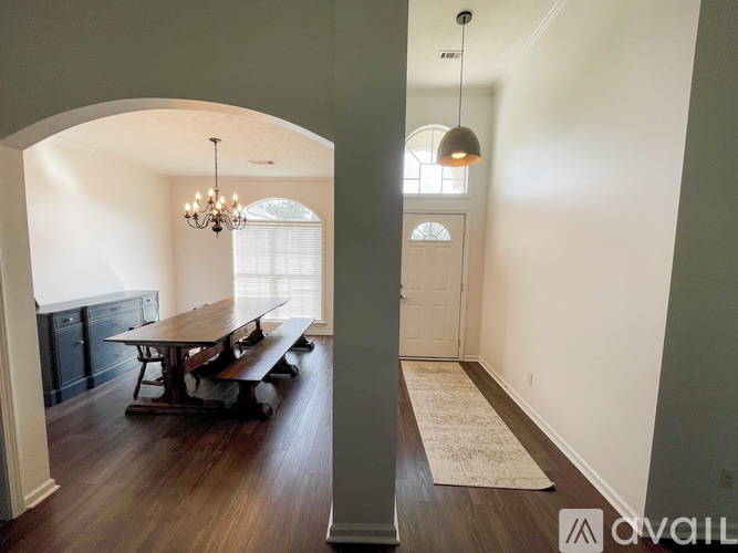 A dining room with a wooden table and benches.
