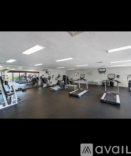 A gym with treadmills, exercise bikes, and other equipment.