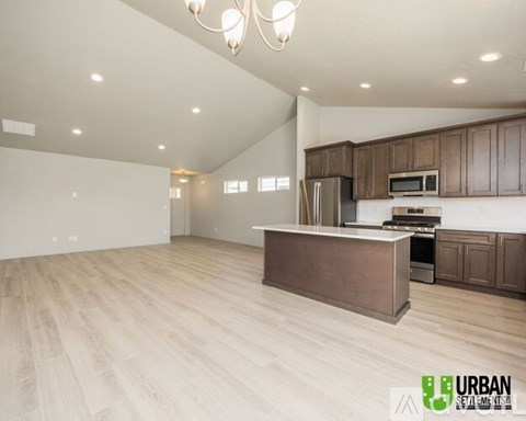 A spacious kitchen with wooden cabinets and a central island.