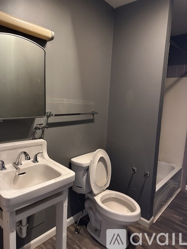 A white sink and toilet in a bathroom.