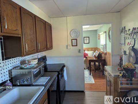 A kitchen with wooden cabinets and a black stove top oven.
