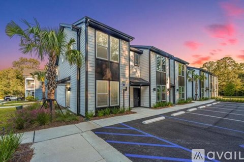 A modern building with a parking lot in front of it.
