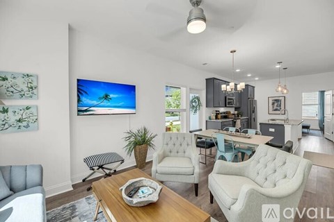 A living room with a flat screen TV mounted on the wall.