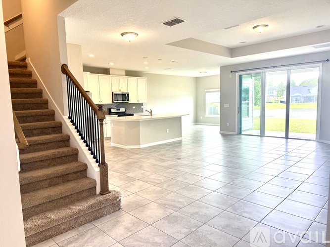 A living room with a staircase leading to the upper floor.
