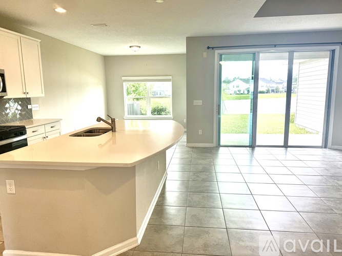 A kitchen with a white countertop and a window.