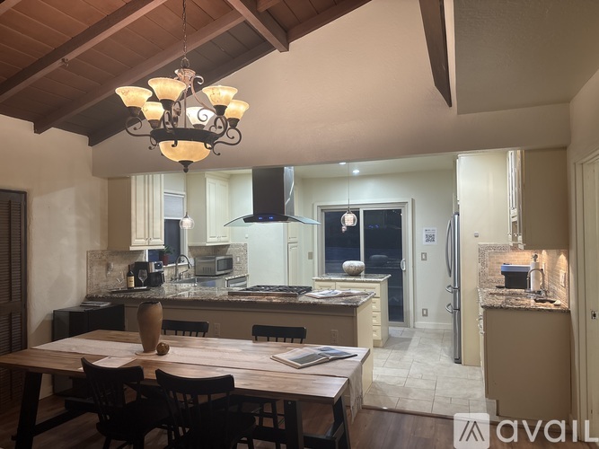 A modern kitchen with a dining table set for four.