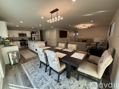 A modern dining room with a large table and chairs.