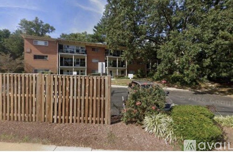 A modern building with a wooden fence in front of it.