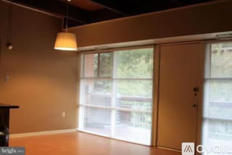 A room with a brown wall and a large window.