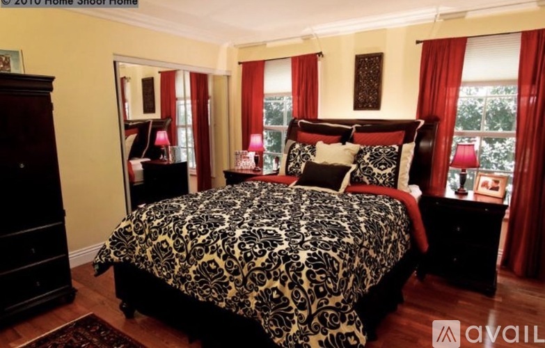 A bedroom with a large bed and a dresser.