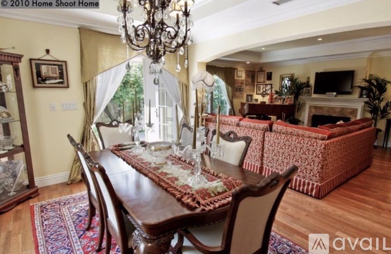 A dining room with a wooden table and chairs.