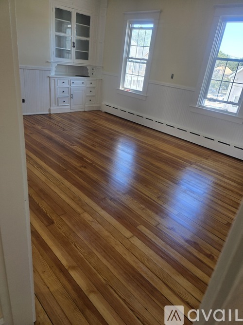 A room with wooden floors and white walls.
