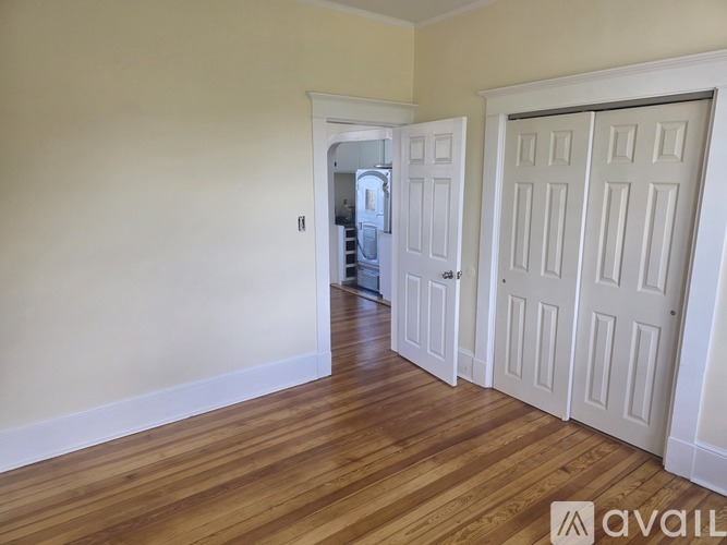 A room with wooden floors and white doors.