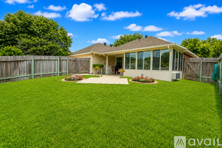 A house with a large lawn and a fence.