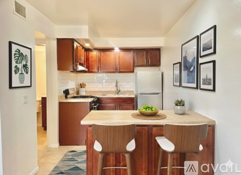 A kitchen with wooden cabinets and a white refrigerator.