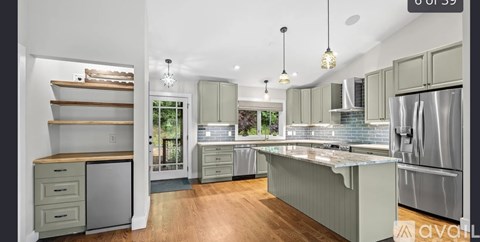 A kitchen with a refrigerator, stove, and oven.