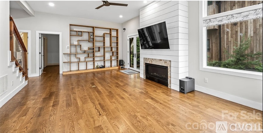 A living room with a fireplace and a television.