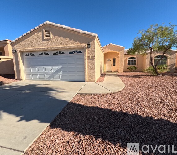 A house with a garage door and a driveway.