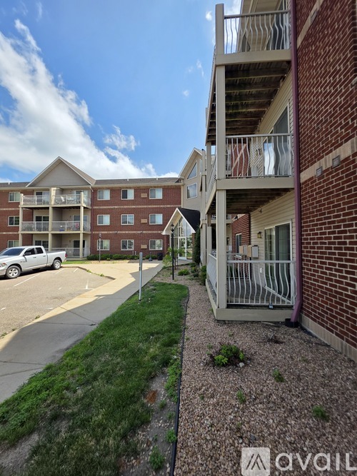 Apartment complex with a car parked in the driveway.