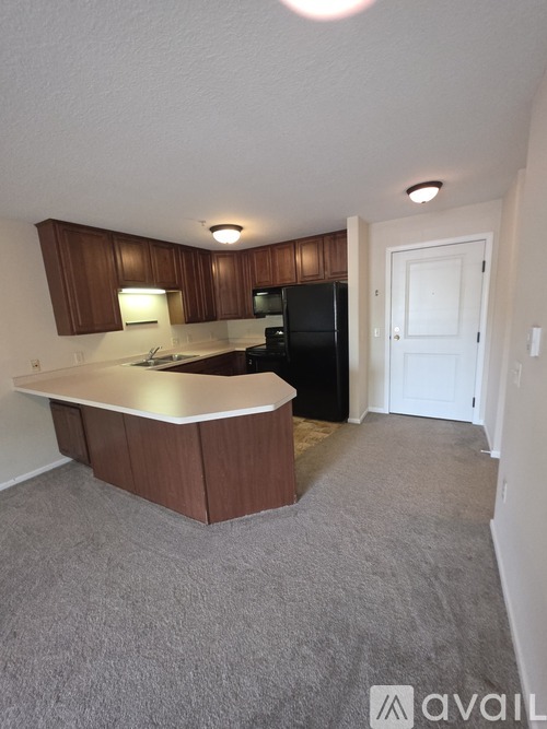A kitchen with a white countertop and brown cabinets.
