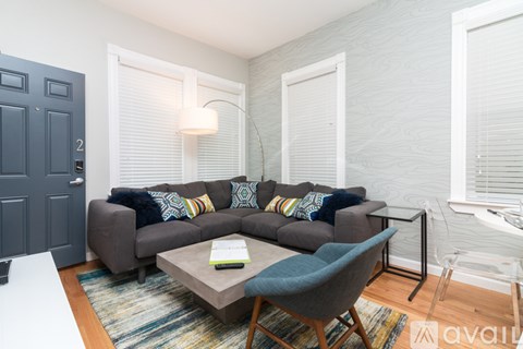 A living room with a grey couch and a coffee table.