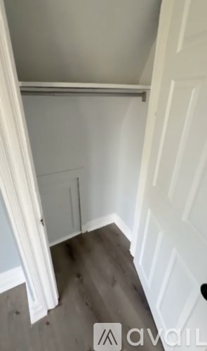 A white door is open to a hallway.